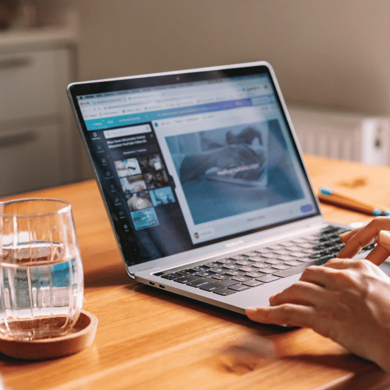 Real estate agent creating an email newsletter on a laptop
